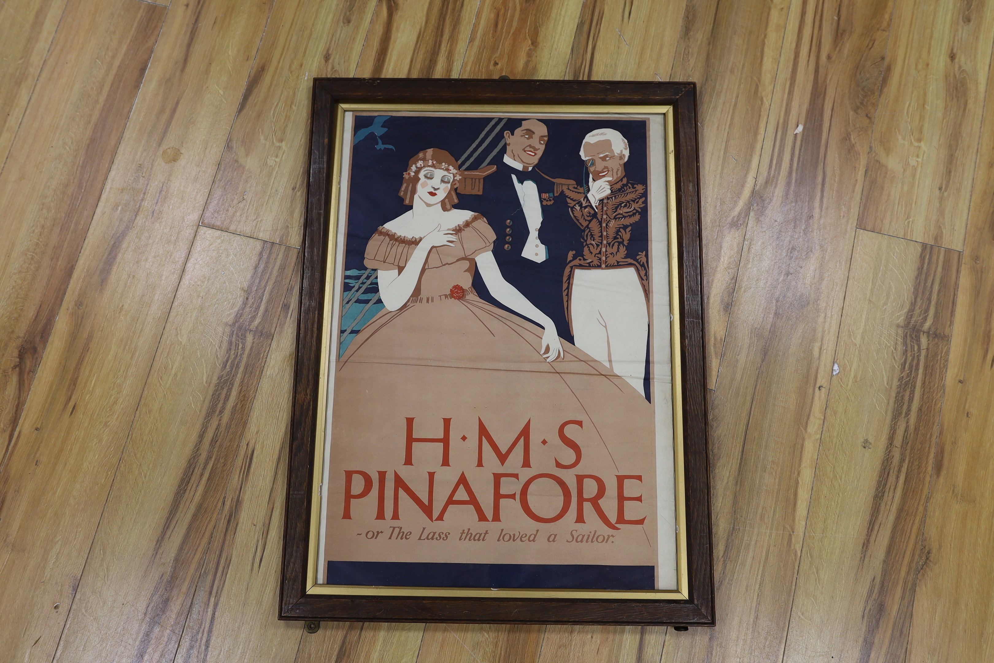 An early 20th century lithograph poster for Gilbert & Sullivan’s H.M.S. Pinafore, in an oak frame, together with a framed play bill, another framed poster, a large framed production photograph and a framed photo montage